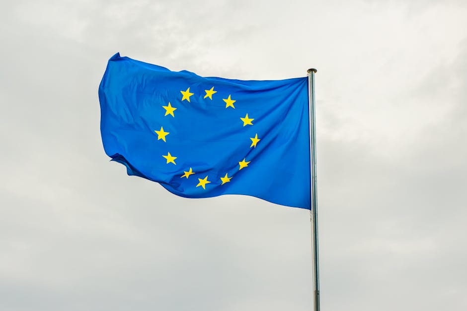EU flag overlaid with cybersecurity shield symbolizing NIS2 compliance