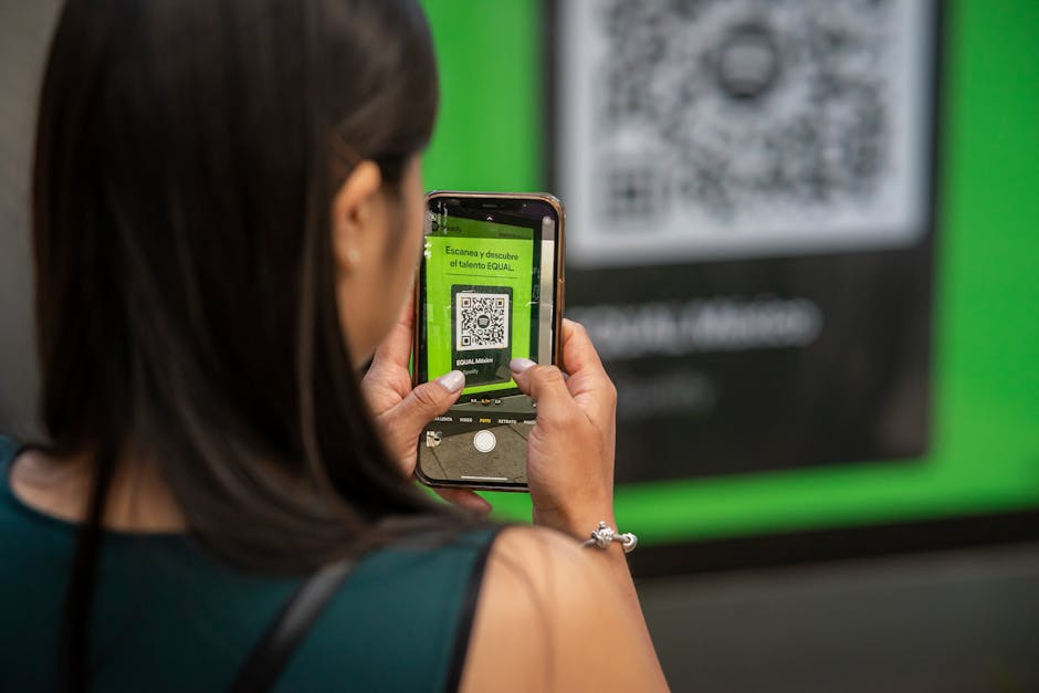 Smartphone scanning a QR code with a warning overlay indicating a phishing threat