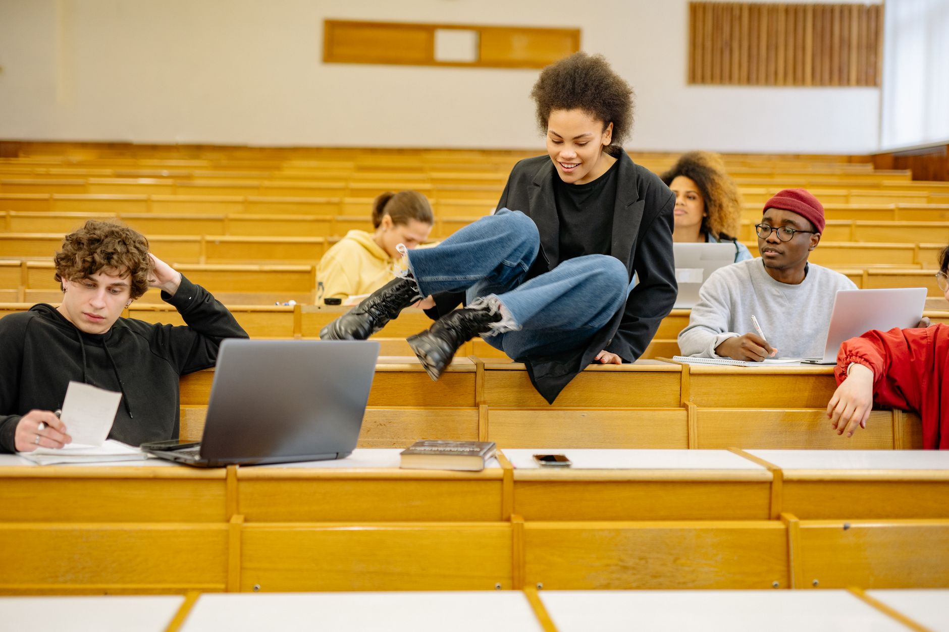 University students walking across campus with laptops and backpacks at the start of the semester