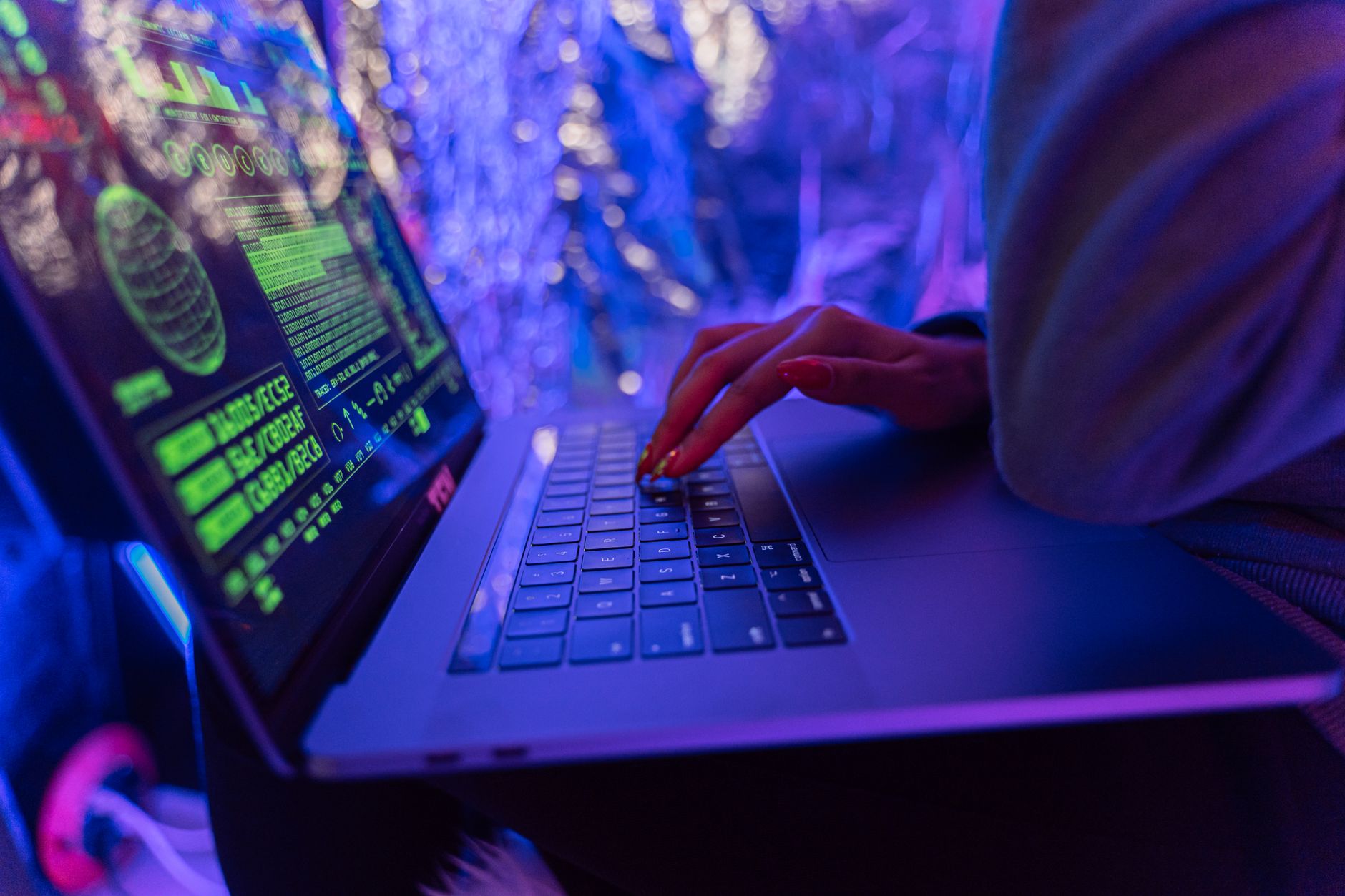 A laptop screen displaying code, representing an information-stealing malware attack