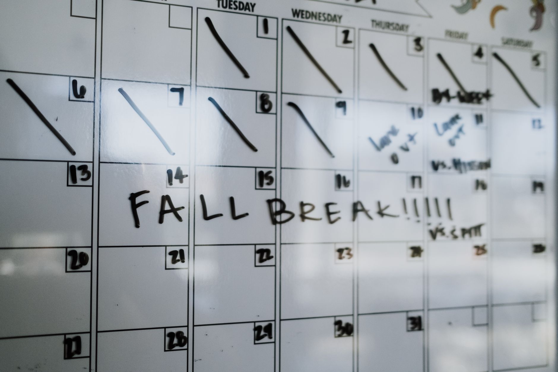 Security awareness team planning an October campaign calendar on a whiteboard in September