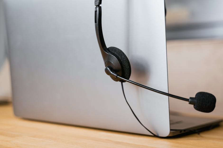 IT help desk agent wearing a headset and assisting a caller