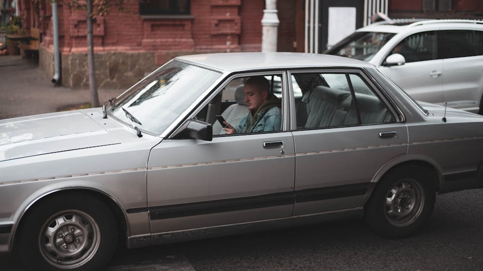 Driver checking a suspicious toll payment text message on a mobile phone
