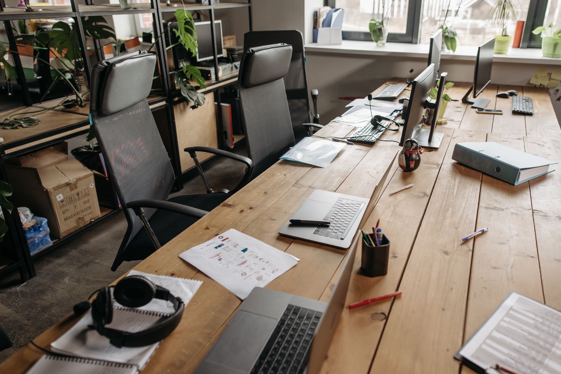 Empty office desk with a closed laptop during the summer vacation period