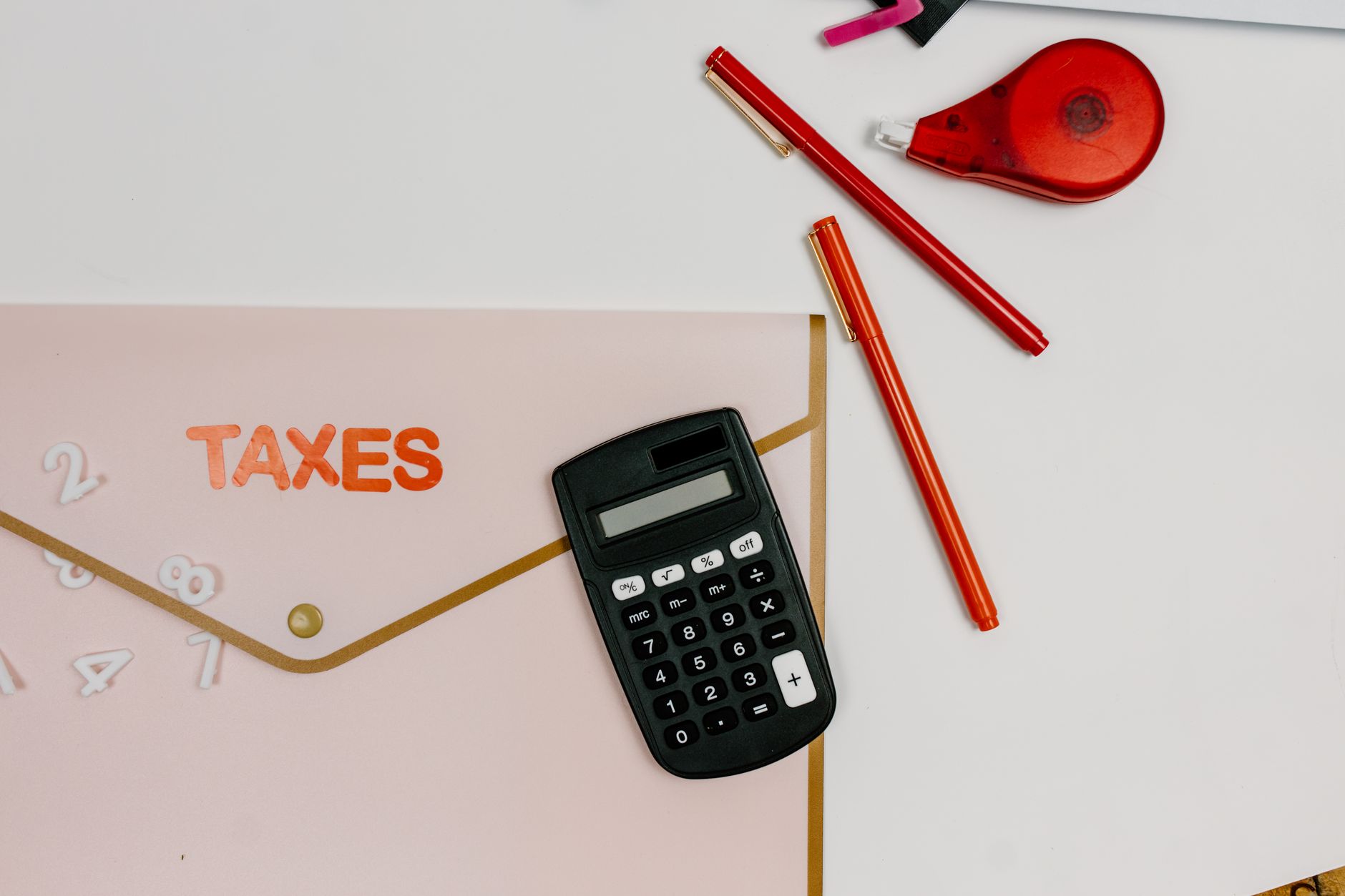 Tax forms and a calculator on a desk during tax filing season