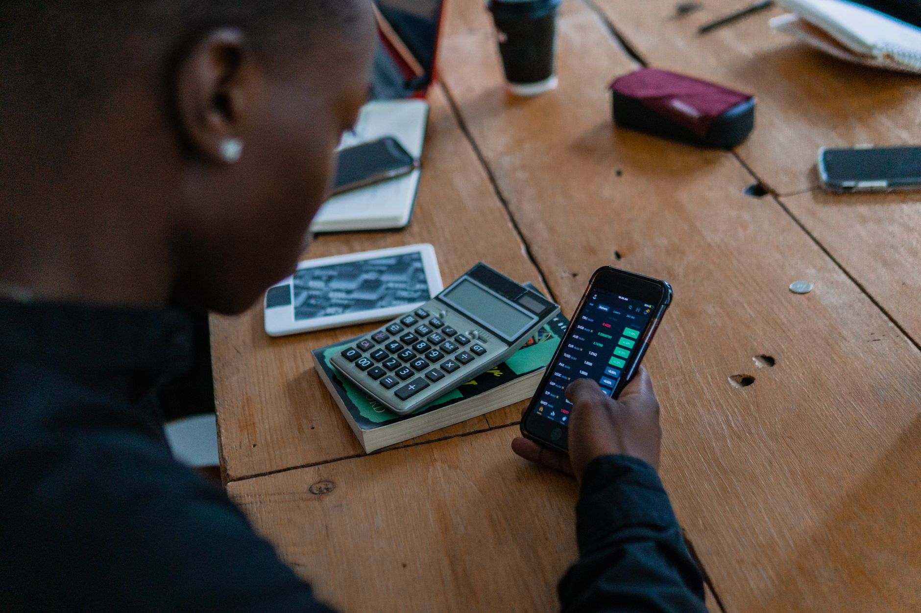 Employee reading a text message on a smartphone at work