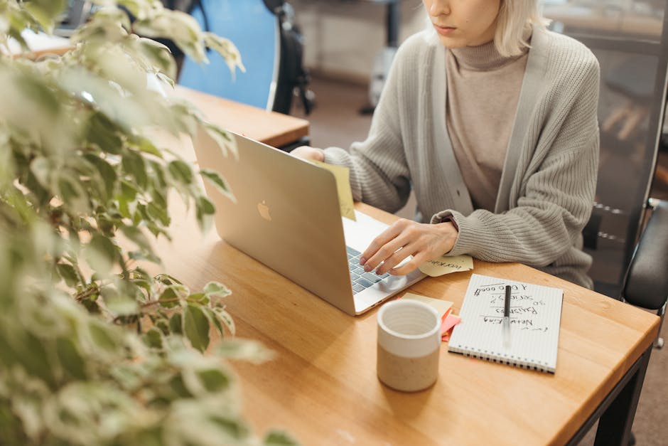 An employee carefully reading an email thread on an office computer