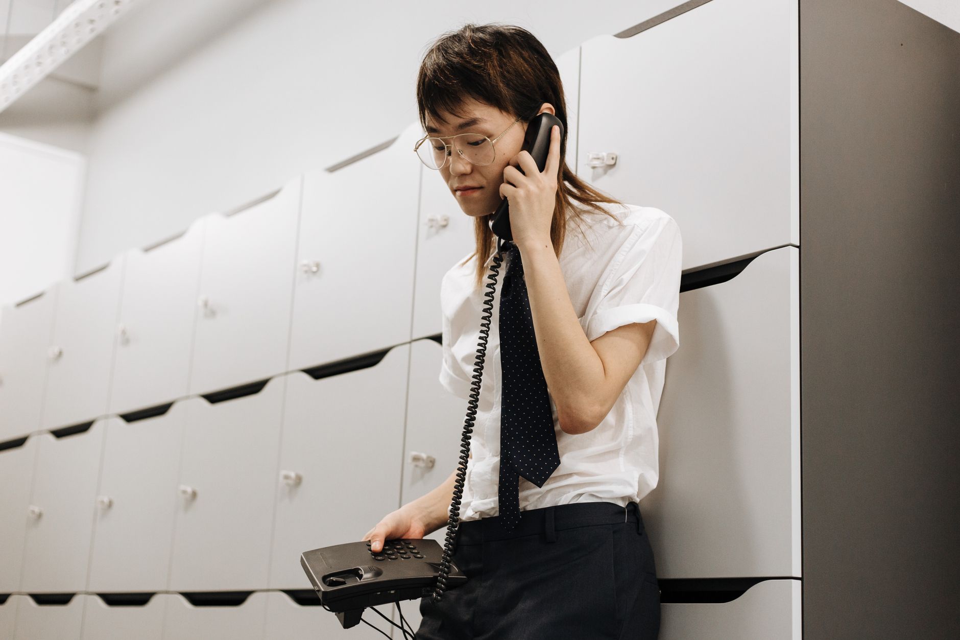 Office worker answering an unexpected phone call at their desk